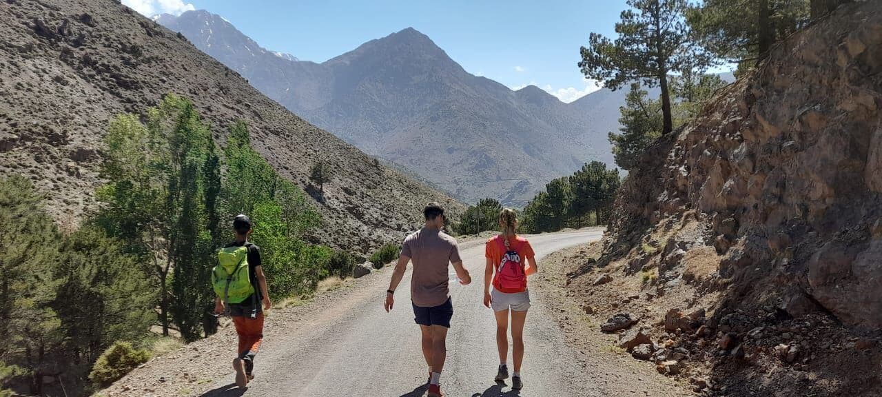 Hikers descending toward Imlil after a full-day Talamrout Summit hike